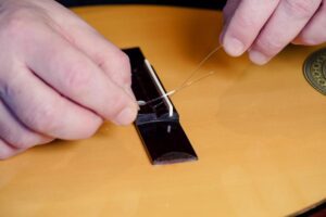 Restring a classical guitar
