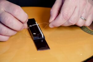Restring a classical guitar