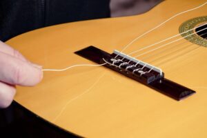 Restring a classical guitar instructions.