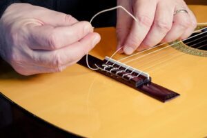 Restring a classical guitar instructions.