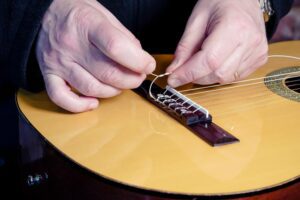 Restring a classical guitar instructions.