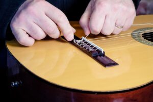 Restring a classical guitar instructions.