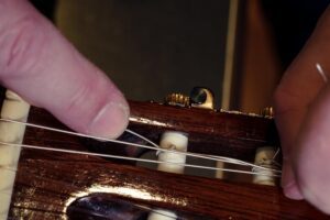 Restring a classical guitar. Local company