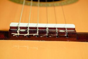 Restring a classical guitar. Local company